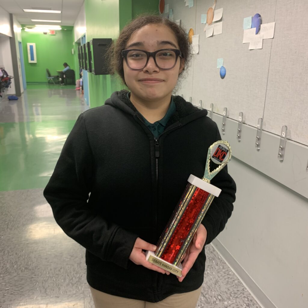Student Jordana Corrizosa-Pena holding a trophy she won at the school's debate contest.